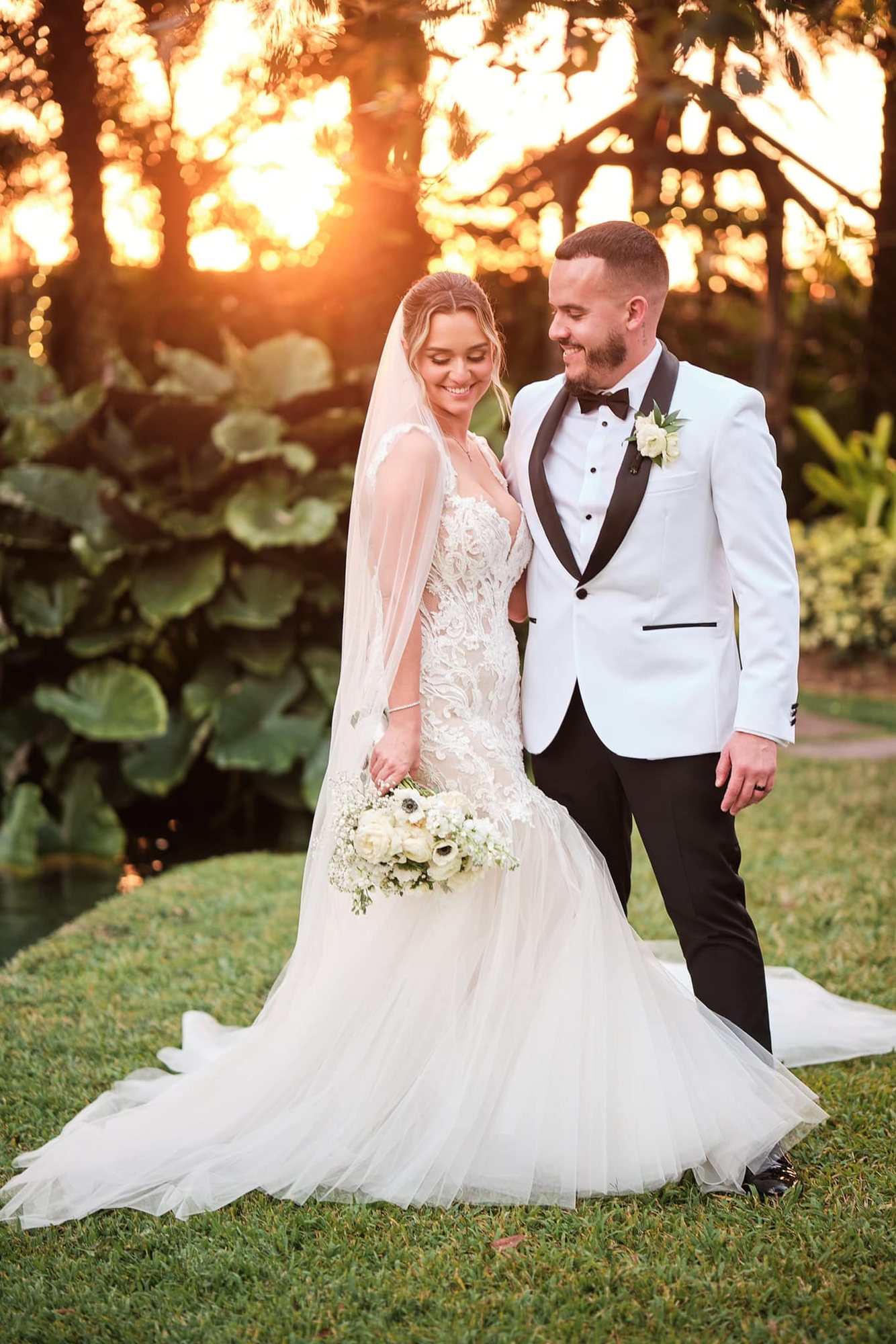 Bride holding a cascading white floral bouquet
